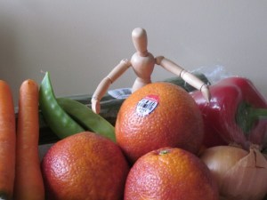 little wooden man with veggies